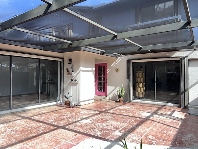 view of patio featuring a lanai