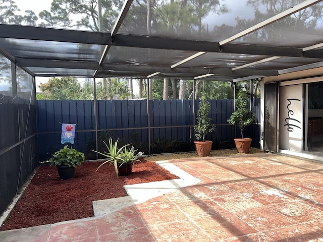 view of patio / terrace featuring glass enclosure