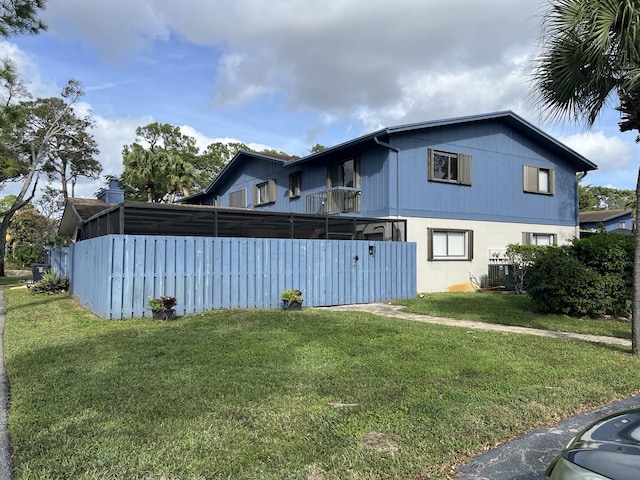 view of property exterior with cooling unit and a lawn