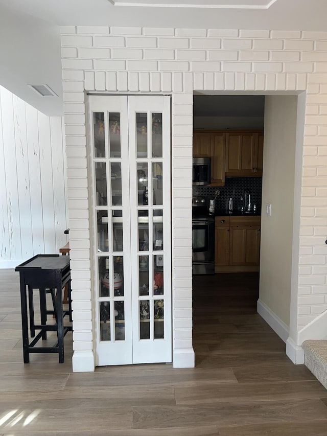 corridor with sink and dark hardwood / wood-style floors