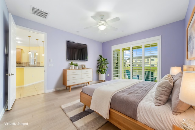 bedroom featuring ceiling fan, access to exterior, and light hardwood / wood-style floors