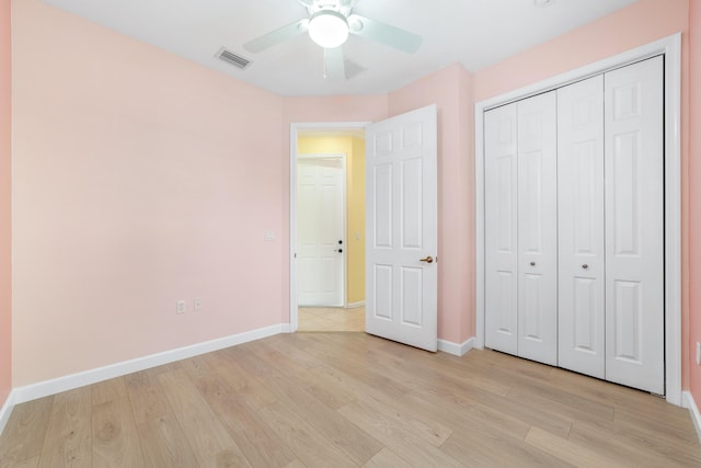 unfurnished bedroom featuring ceiling fan, a closet, and light hardwood / wood-style floors