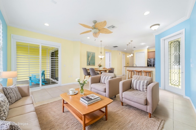 living room featuring ceiling fan, light tile patterned floors, and crown molding