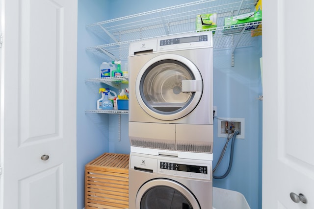 washroom featuring stacked washer and dryer