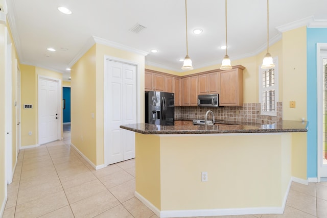 kitchen featuring kitchen peninsula, refrigerator with ice dispenser, dark stone countertops, hanging light fixtures, and crown molding