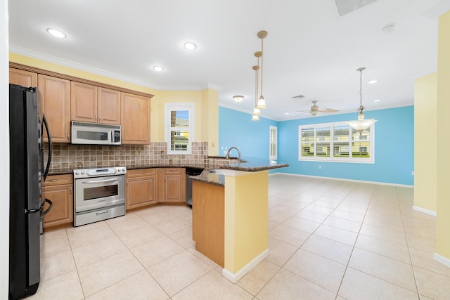 kitchen featuring kitchen peninsula, ceiling fan, appliances with stainless steel finishes, decorative backsplash, and decorative light fixtures