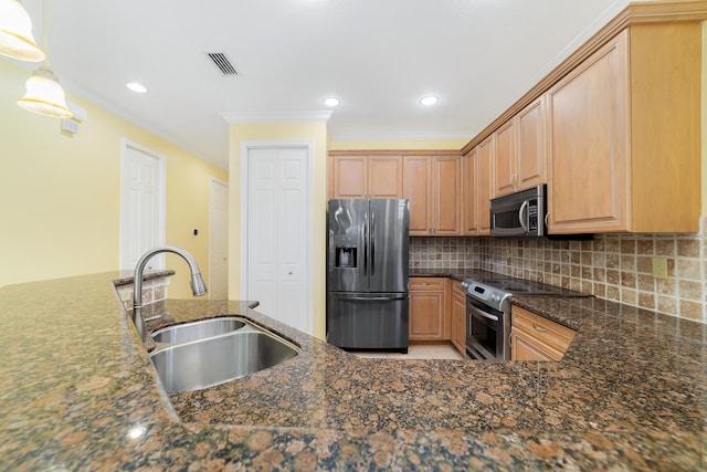 kitchen with decorative light fixtures, backsplash, sink, stainless steel appliances, and dark stone counters