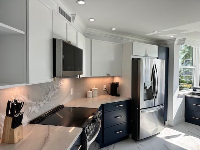 kitchen featuring marble finish floor, stainless steel appliances, visible vents, white cabinets, and light stone countertops