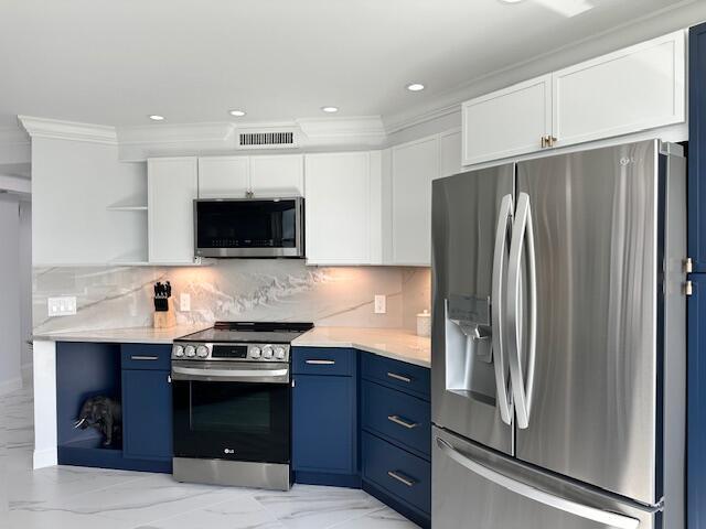 kitchen featuring appliances with stainless steel finishes, blue cabinets, light countertops, and open shelves