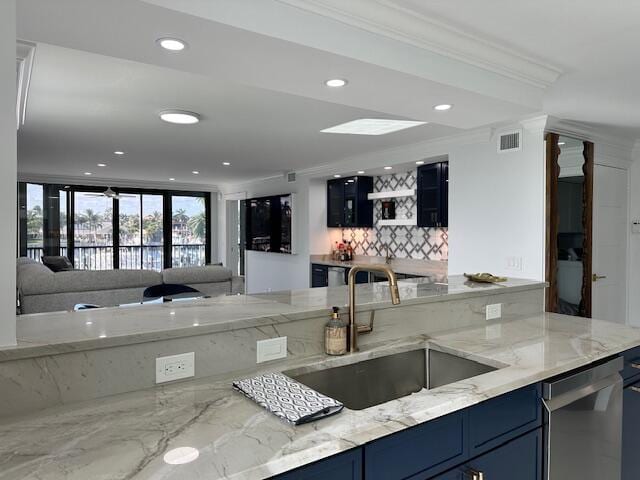 kitchen with blue cabinets, a sink, visible vents, open floor plan, and dishwasher