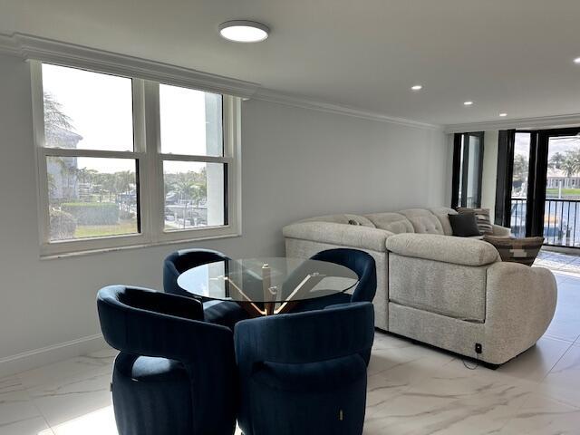 living room featuring recessed lighting, marble finish floor, crown molding, and baseboards