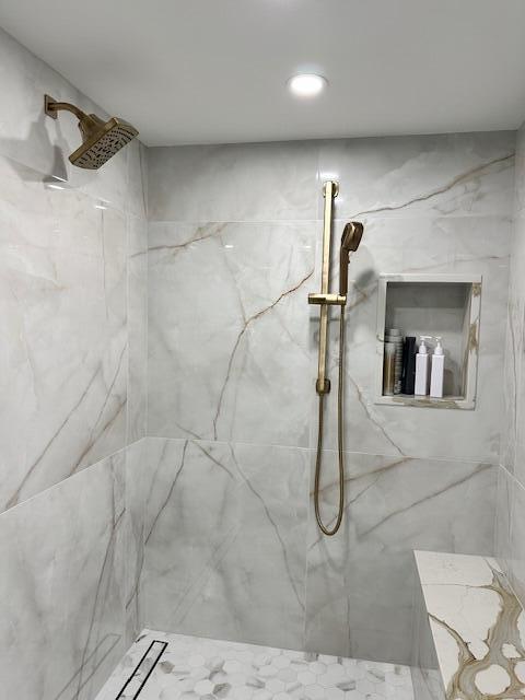 full bath featuring a marble finish shower