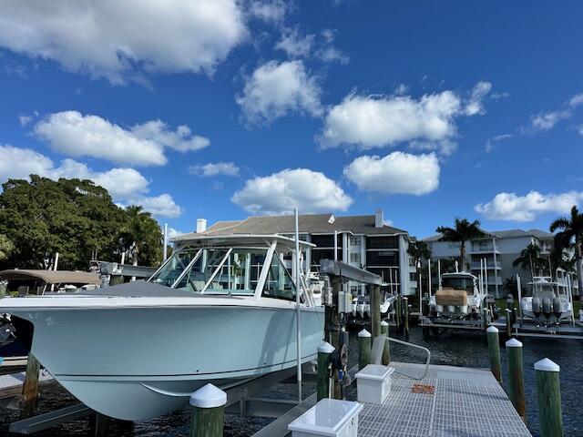 dock area with a water view and boat lift