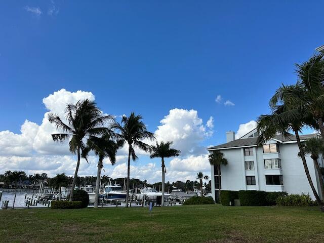 surrounding community with a lawn and a water view