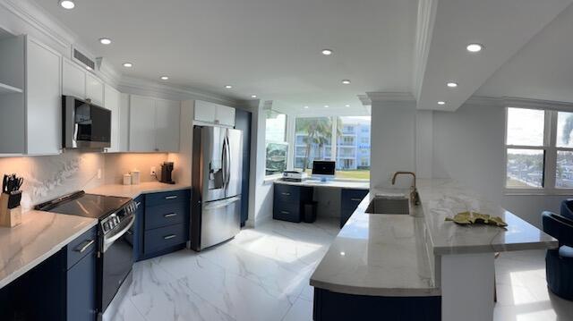 kitchen featuring marble finish floor, a large island, blue cabinetry, appliances with stainless steel finishes, and white cabinets