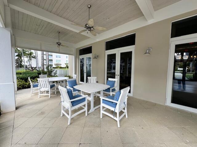 view of patio / terrace featuring outdoor dining area, ceiling fan, and french doors