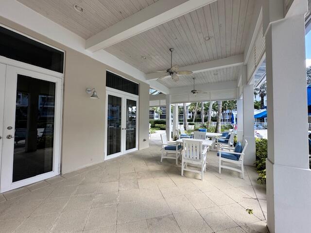 view of patio with outdoor dining area and a ceiling fan