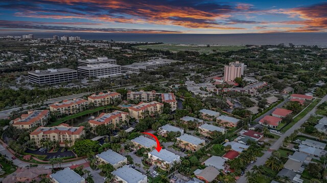 birds eye view of property with a city view and a water view