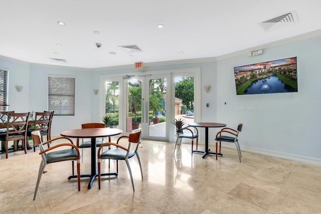 dining space with baseboards, ornamental molding, and visible vents