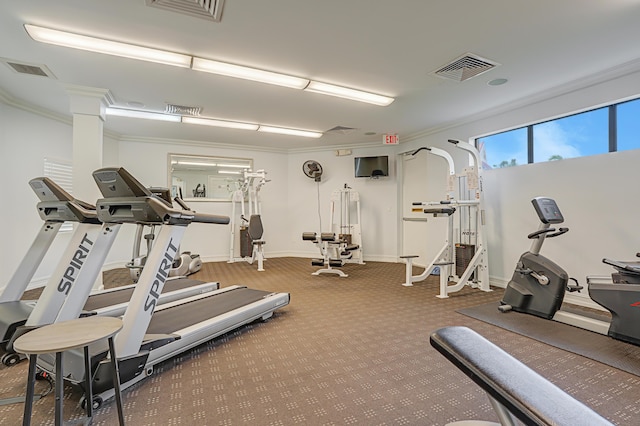 exercise room featuring visible vents and crown molding