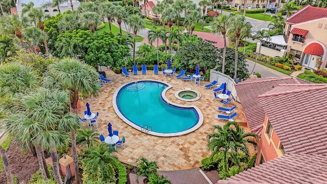 pool featuring a residential view, a community hot tub, and a patio area