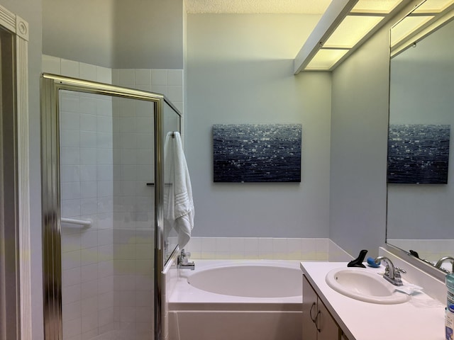 bathroom with vanity and separate shower and tub