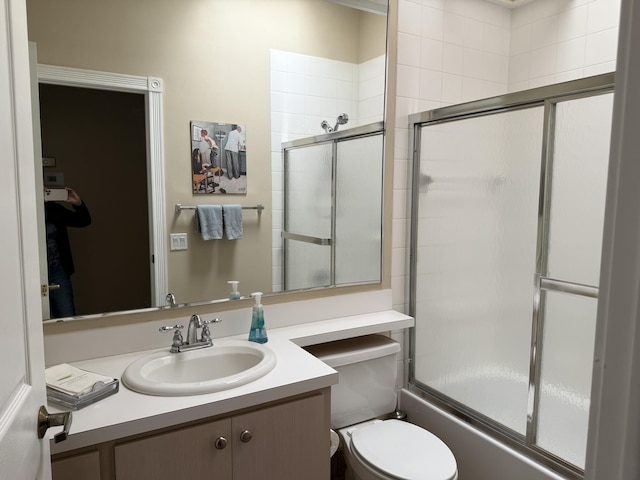 full bathroom with vanity, combined bath / shower with glass door, and toilet