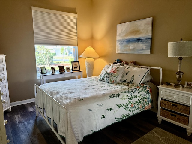 bedroom with dark hardwood / wood-style floors