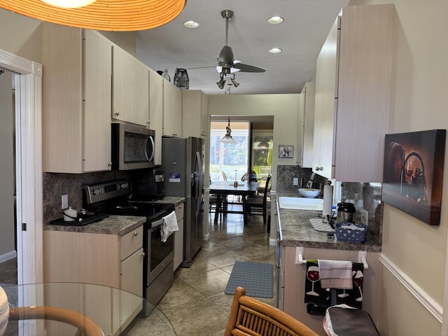 kitchen featuring stainless steel appliances, light tile patterned floors, decorative backsplash, ceiling fan, and light brown cabinets