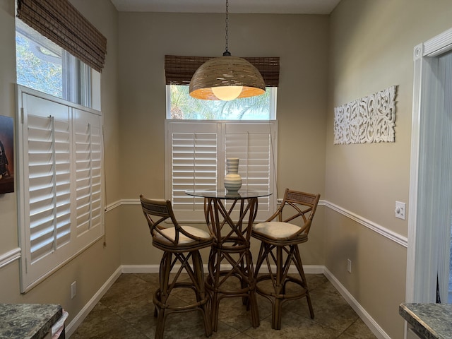 dining room with dark tile patterned floors