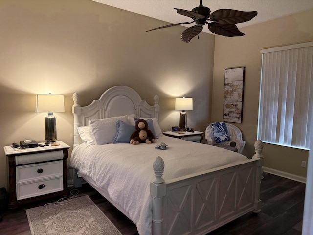 bedroom with a textured ceiling, dark wood-type flooring, and ceiling fan