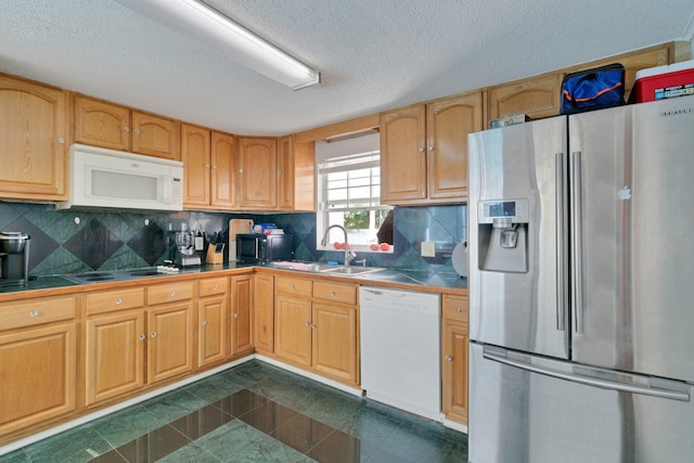 kitchen featuring tile countertops, black appliances, decorative backsplash, and sink