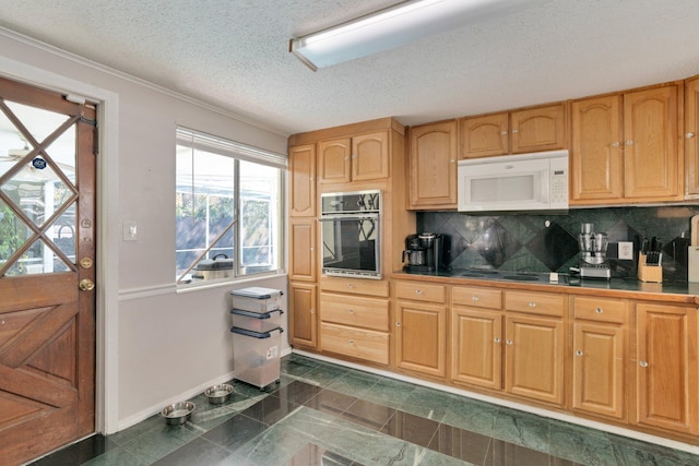 kitchen featuring a textured ceiling, electric stovetop, black oven, and decorative backsplash