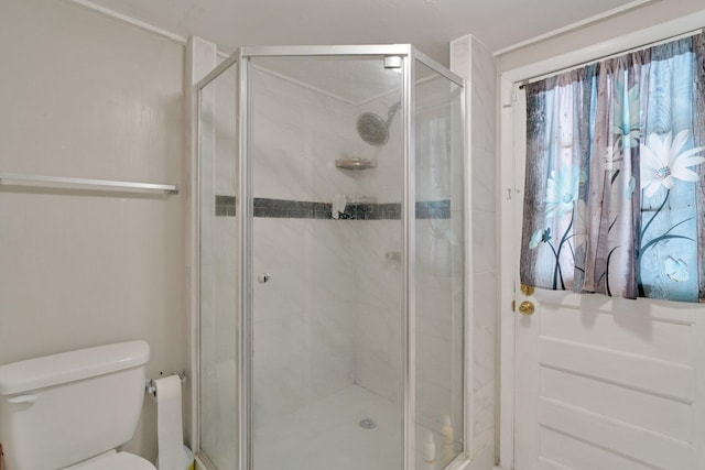 bathroom with toilet and walk in shower