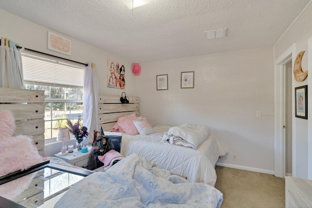 bedroom featuring a textured ceiling and light carpet