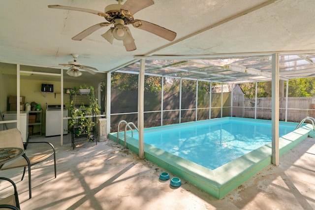 view of pool featuring a patio area, ceiling fan, and glass enclosure