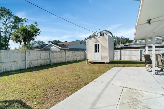 view of yard with a storage unit and a patio