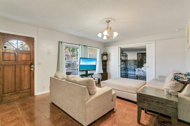 living room featuring a textured ceiling, tile patterned floors, and a chandelier