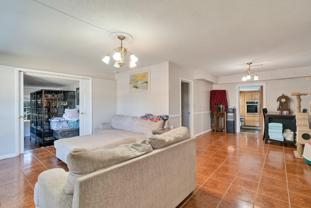 living room with a textured ceiling, tile patterned floors, and a chandelier