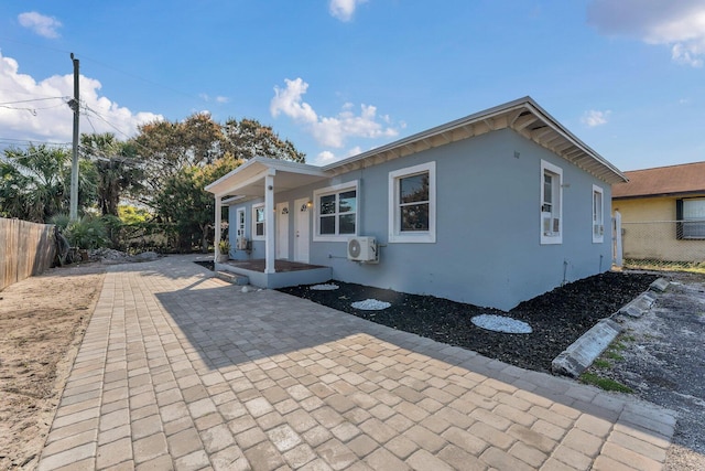 exterior space with ac unit and a patio