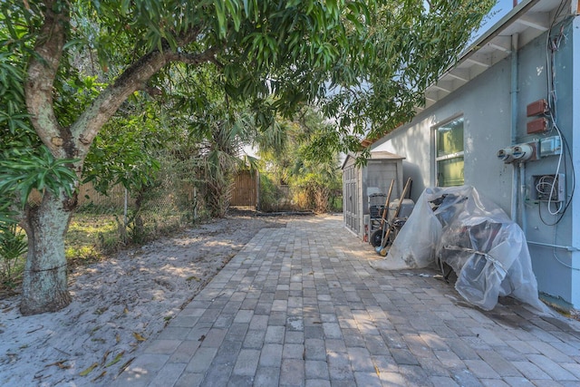 view of patio featuring a storage unit