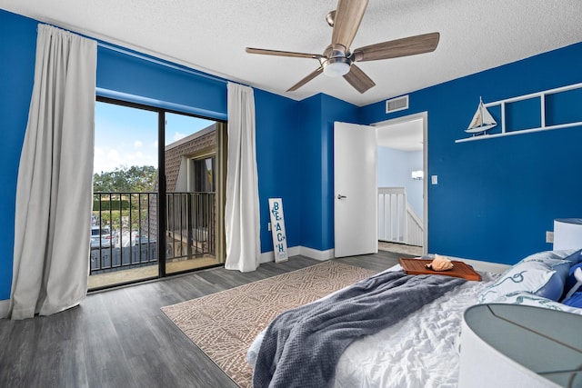 bedroom with dark hardwood / wood-style flooring, access to exterior, ceiling fan, and a textured ceiling