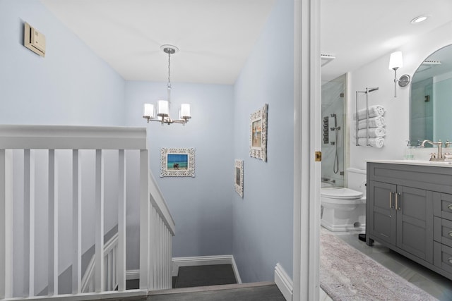 stairway with a notable chandelier and sink