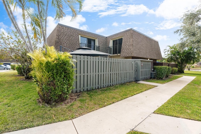 view of side of home with a lawn