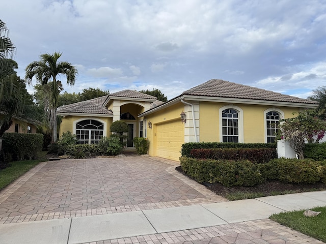 mediterranean / spanish house featuring a garage