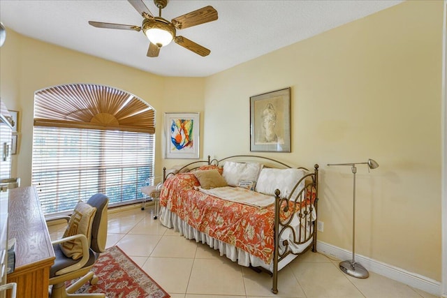 tiled bedroom with ceiling fan