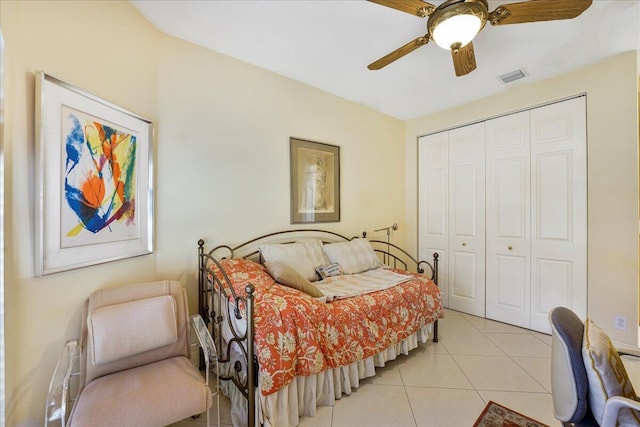 bedroom featuring light tile patterned floors, a closet, and ceiling fan