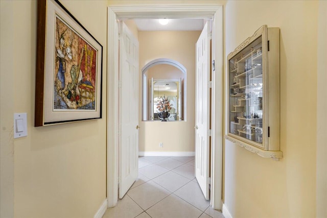 hall featuring light tile patterned flooring