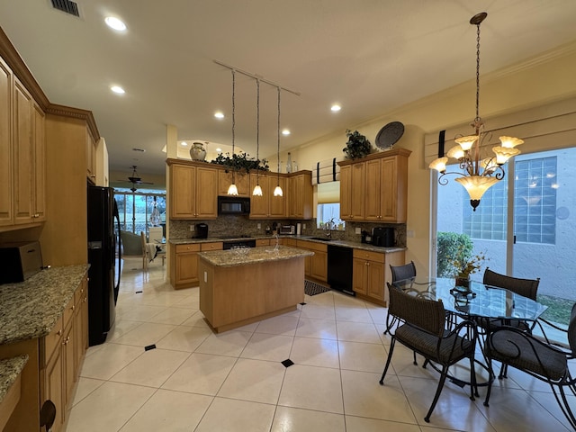 kitchen with a kitchen island, black appliances, hanging light fixtures, track lighting, and ceiling fan with notable chandelier