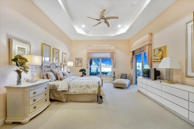 bedroom with a raised ceiling, ornamental molding, carpet flooring, and ceiling fan